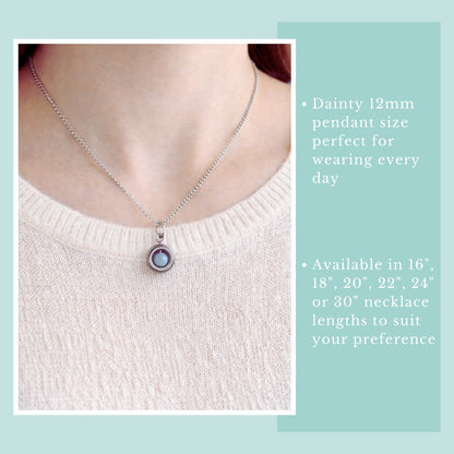 Necklace with a dainty pendant on a person wearing a light pink sweater, with text about necklace length options.