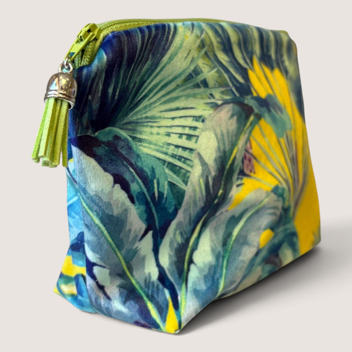 Palm Springs velvet everyday pouch angled to show the palm print, lime green zip and lime green suede tassel with a silver cap