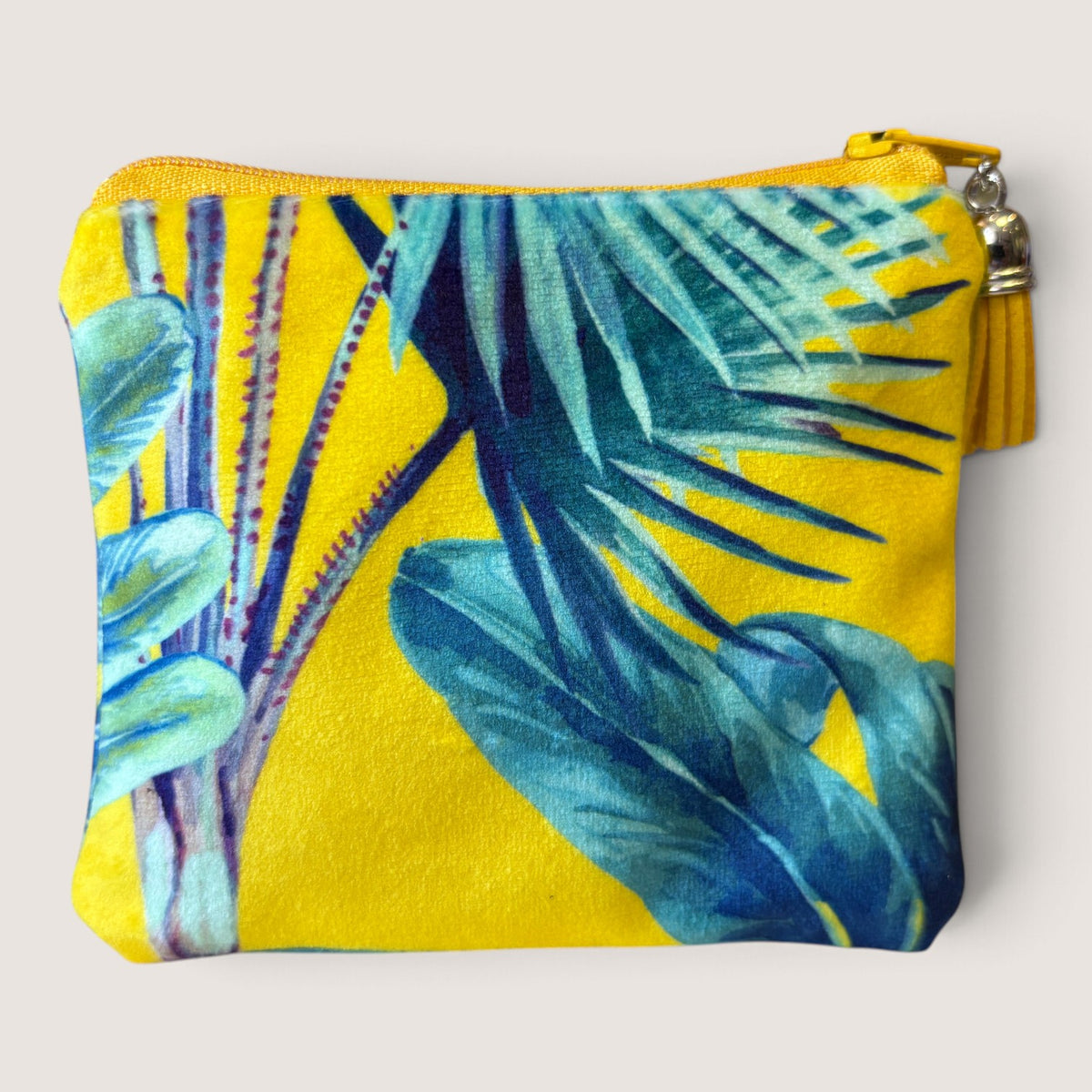 Back of the Palm Springs velvet purse in blue-green palm leaves on yellow with no label, yellow zip and yellow suede tassel