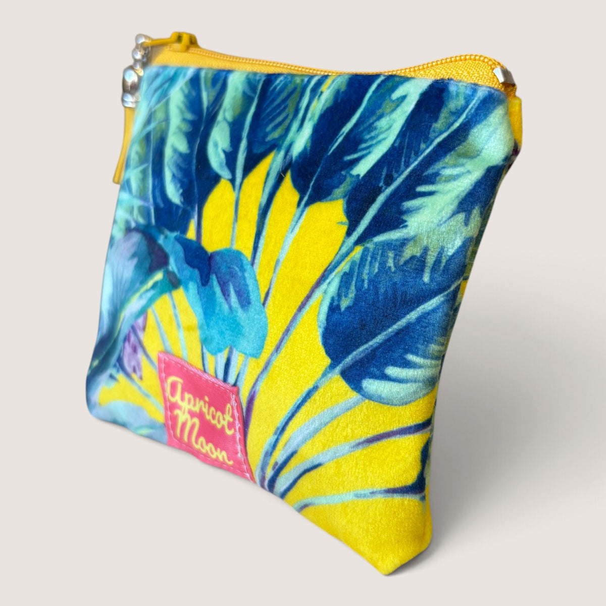 Palm Springs velvet purse in a second angled view, showing the Apricot Moon label on yellow palm print velvet with a yellow zip