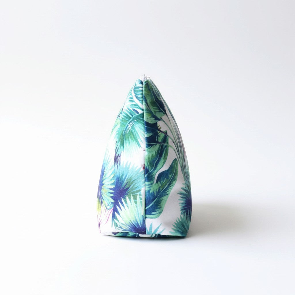 Side view of the Rainforest Velvet wash bag showing the tropical palm leaf print in green, blue and purple on a white background