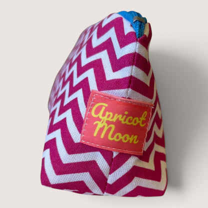 End view of the Raspberry Chevron pencil case showing the Apricot Moon label