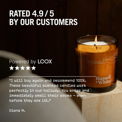 Candle with 'Russell & White' branding on a stone surface, surrounded by text about customer ratings and product satisfaction.