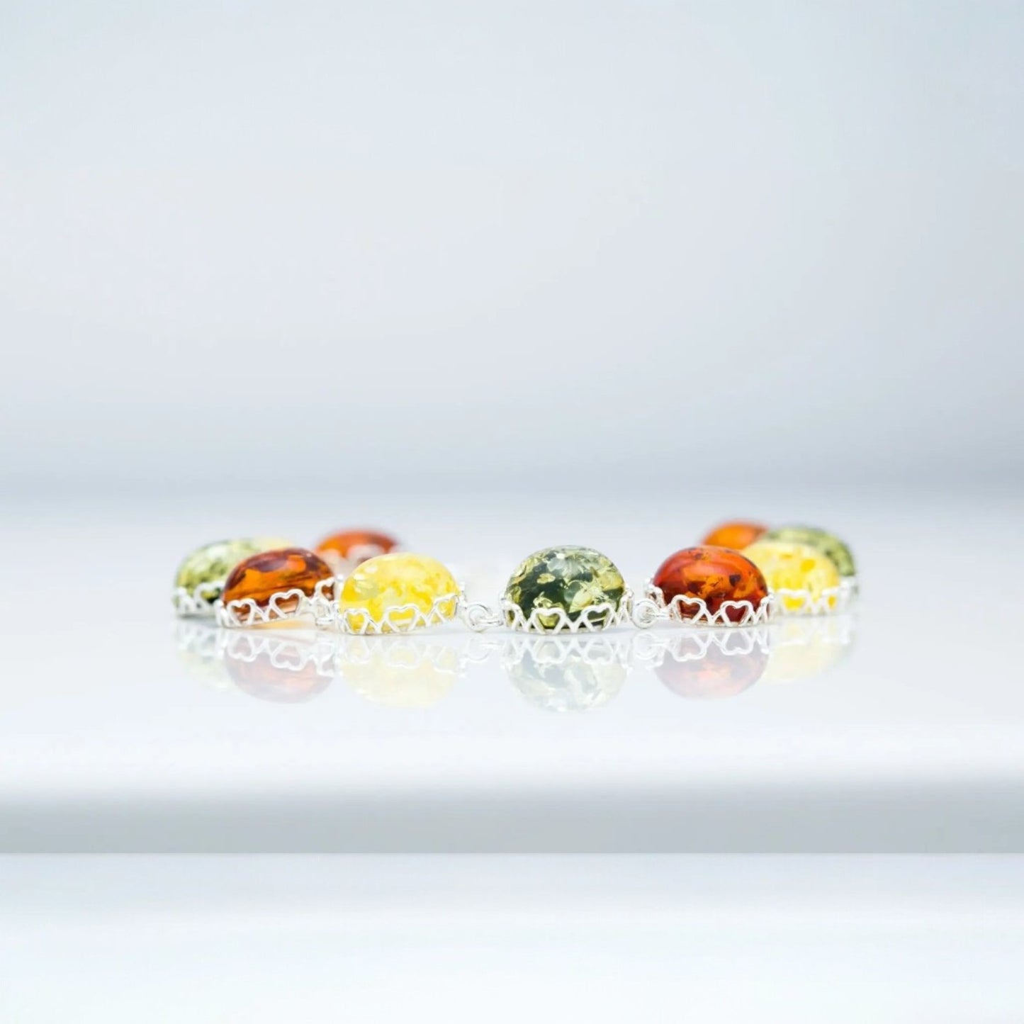 Colorful marbles on a white dish against a light gray background