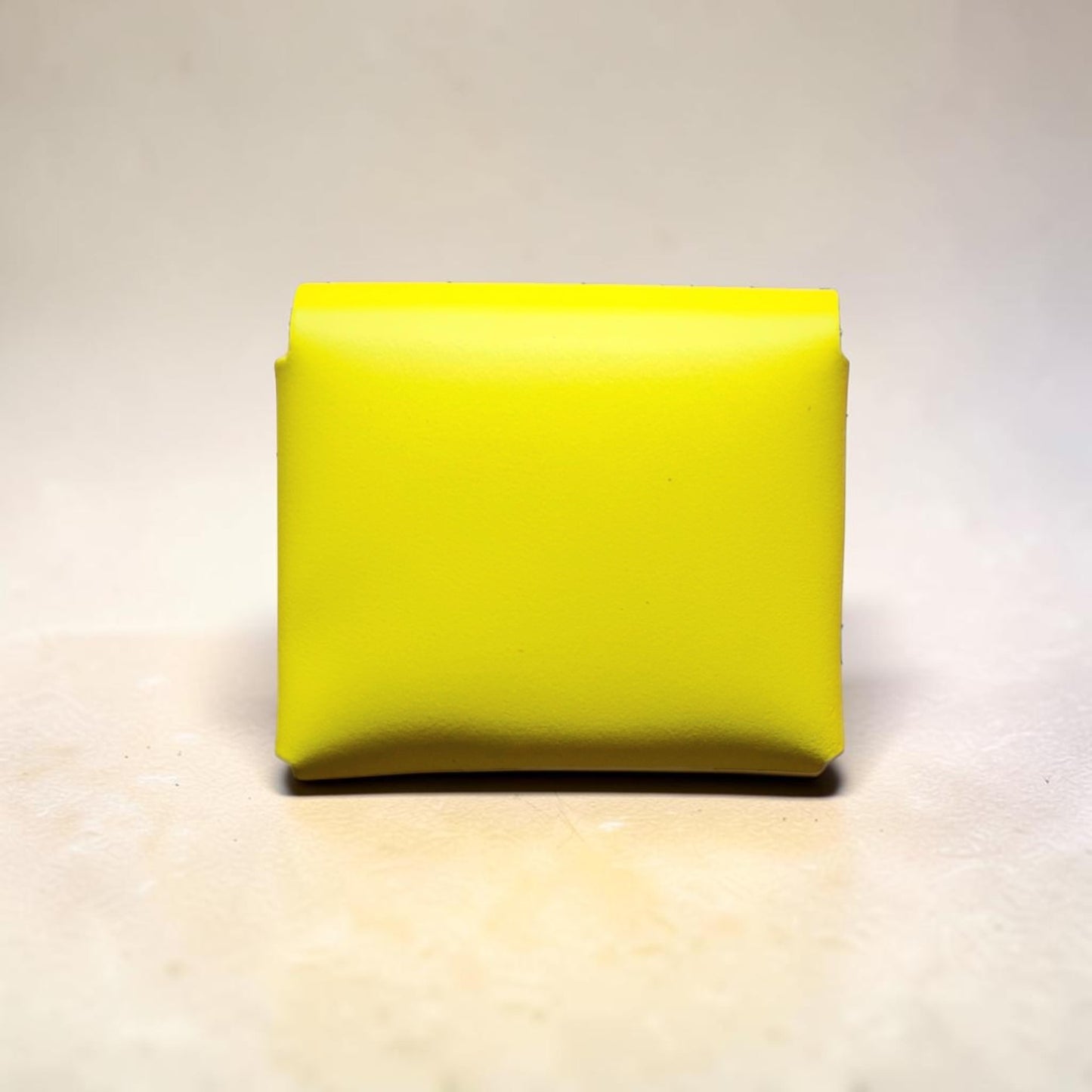 Yellow rectangular object on a light gray background