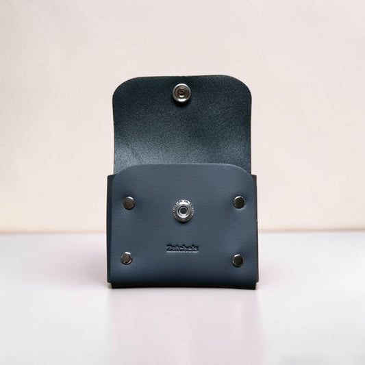 Blue leather wallet with metal fastenings on a light background