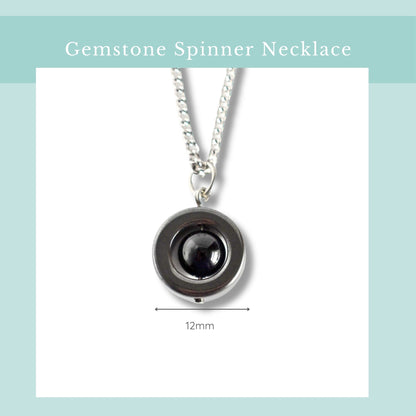 Gemstone spinner necklace with a black gemstone on a white background