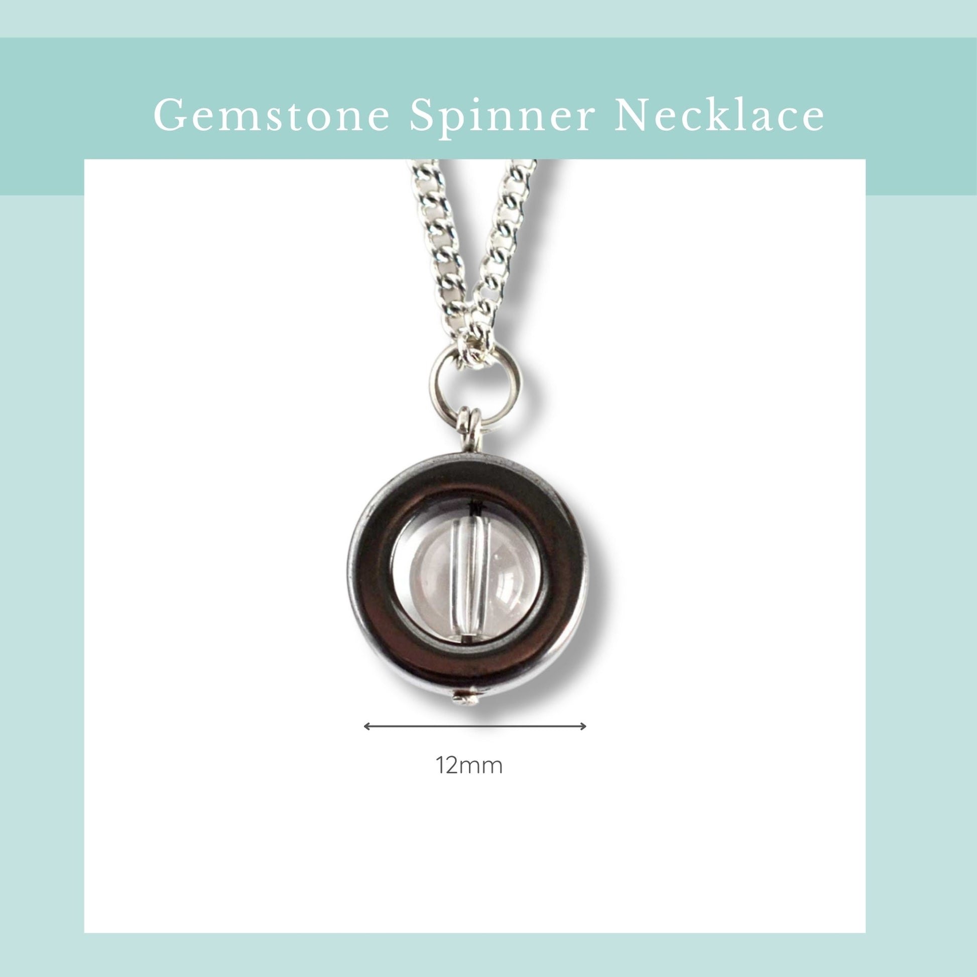 Gemstone spinner necklace with a clear gemstone on a light blue background