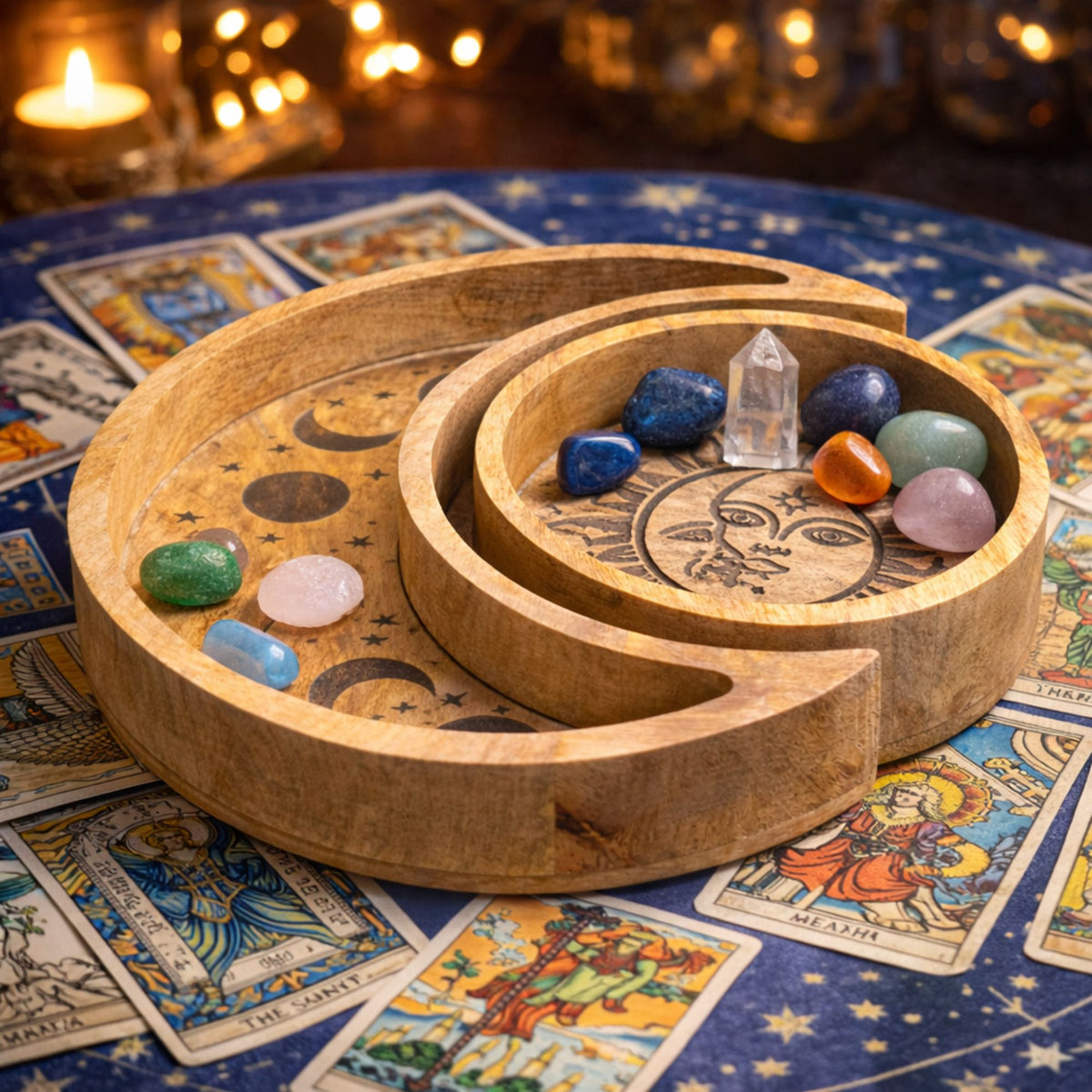 Sun and Moon wooden tray set styled with tumbled crystals and a clear quartz point, surrounded by tarot cards and candlelight