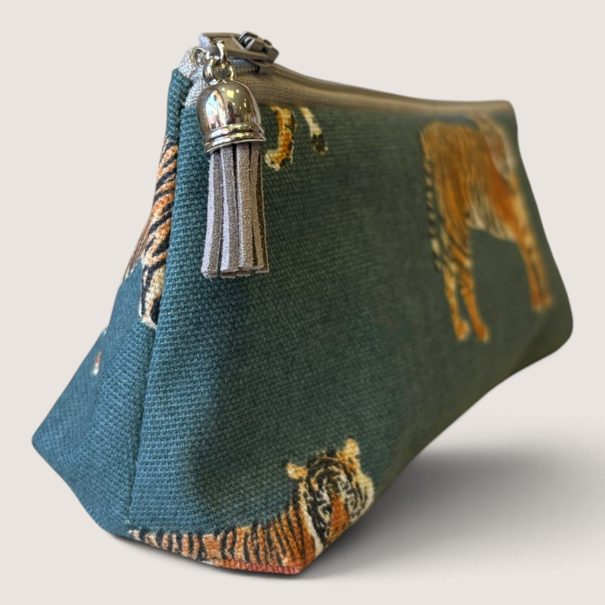 Tiger Tiger pencil case with a grey zip and grey suede tassel, angled view