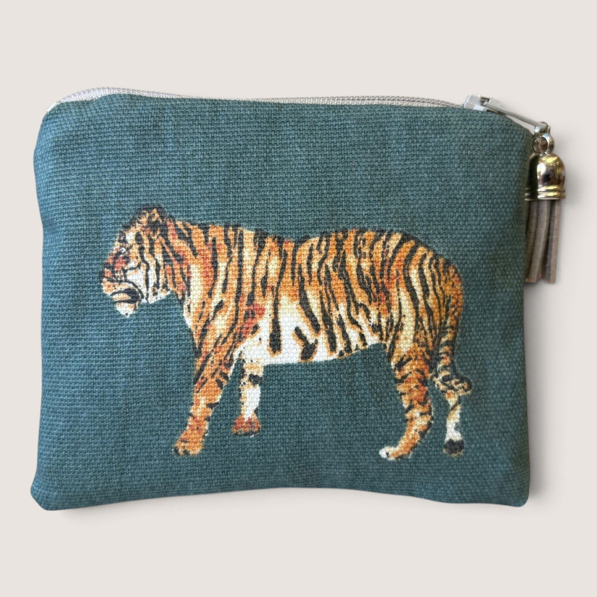Back of the Tiger Tiger purse showing the tiger facing left on deep teal, with an orange zip and dark green suede tassel