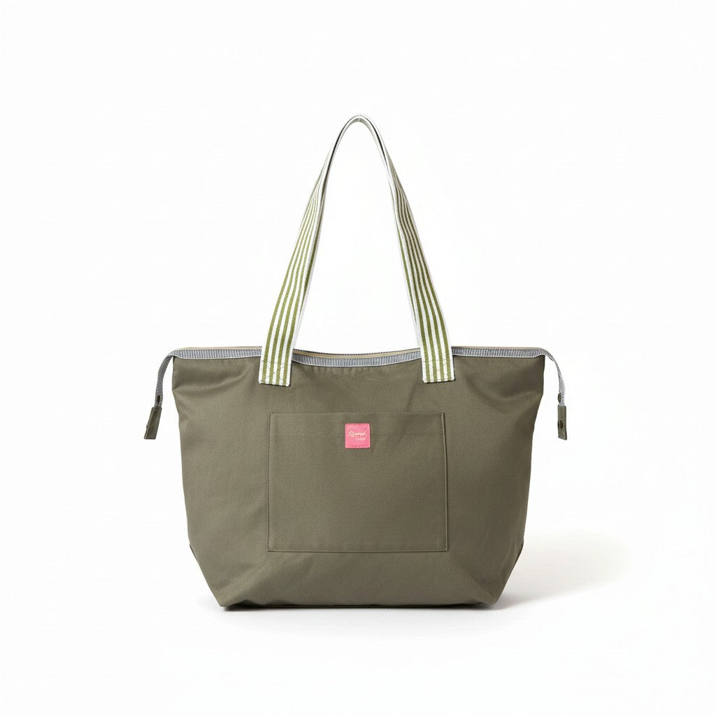 Wild Sage shoulder tote in olive green cotton twill with green and white striped handles and a pink Apricot Moon label on the front pocket, front view studio shot, handmade in Dorset