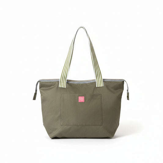 Wild Sage shoulder tote in olive green cotton twill with green and white striped handles and a pink Apricot Moon label on the front pocket, front view studio shot, handmade in Dorset