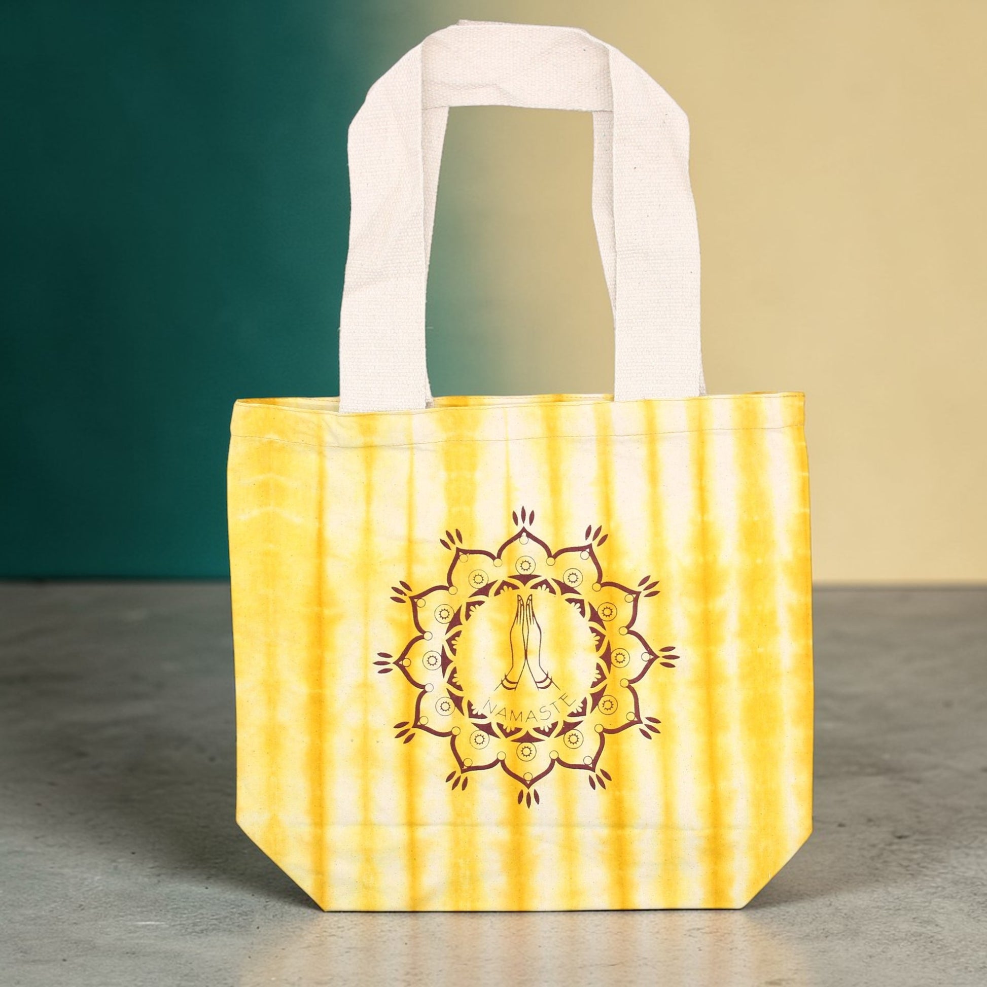 Yellow tote bag with a decorative design on a gradient background