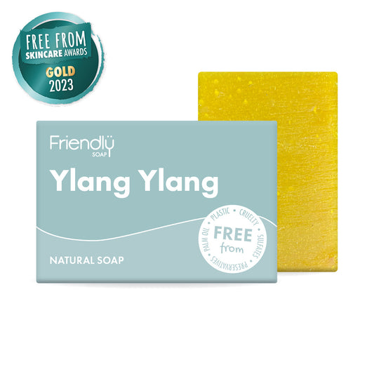 Ylang Ylang natural soap bar with packaging and a yellow sponge on a white background
