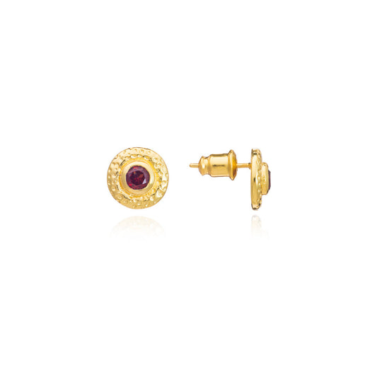 Gold earrings with a red gemstone on a white background