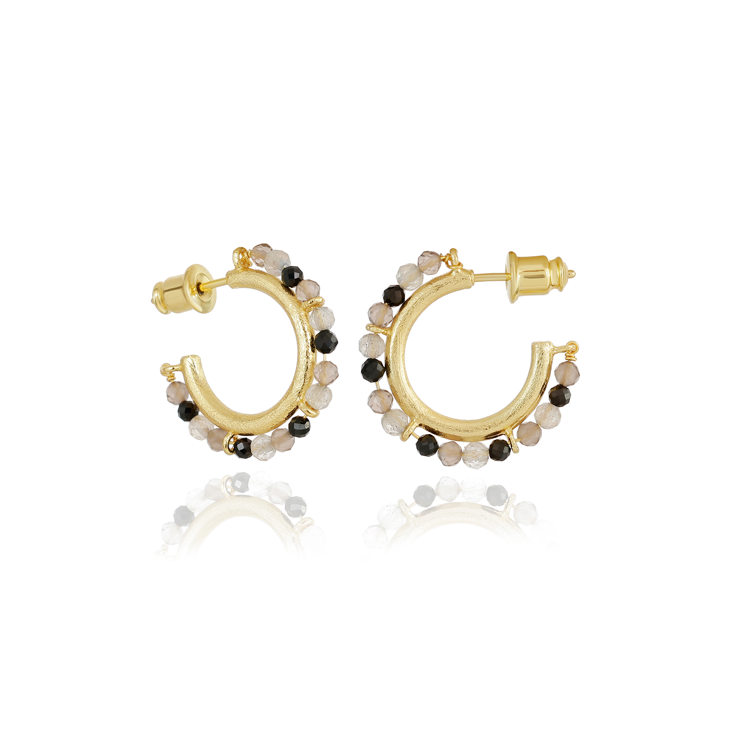 Gold hoop earrings with black and white bead accents on a white background