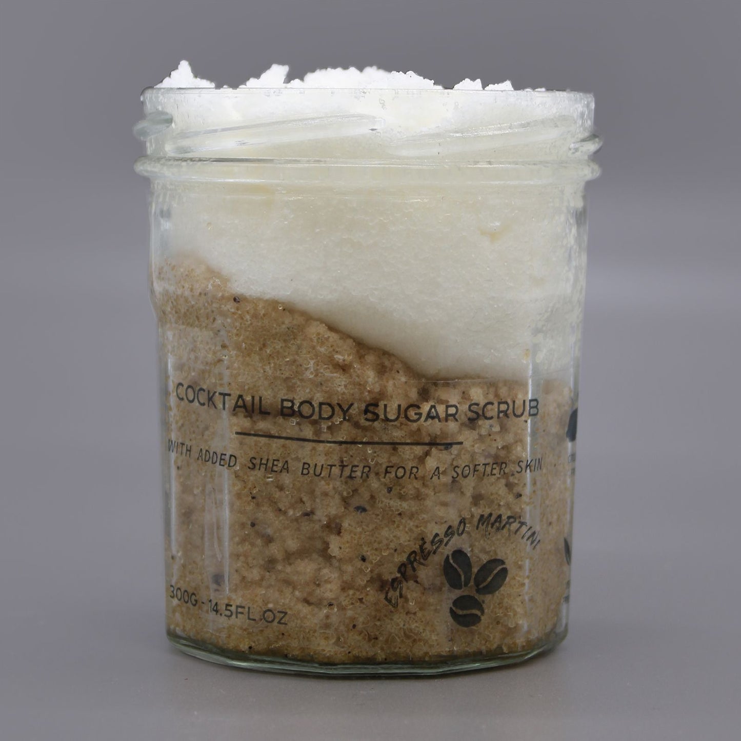 Jar of cocktail body sugar scrub with a gray background