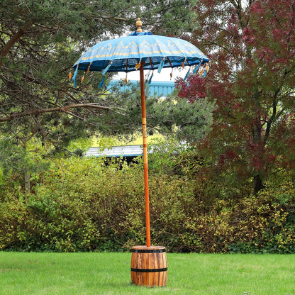 Decorative outdoor umbrella with wooden base in a garden setting