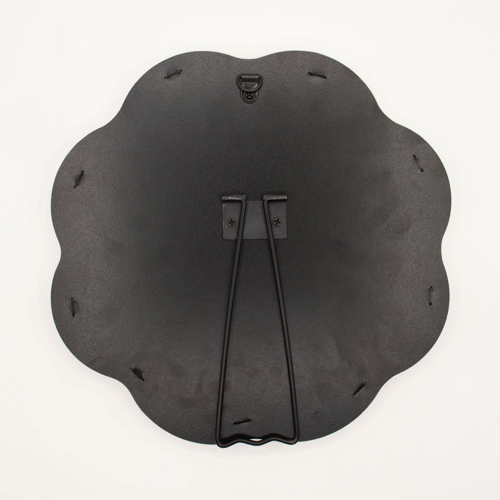 Black metal wall art piece with decorative design on a white background