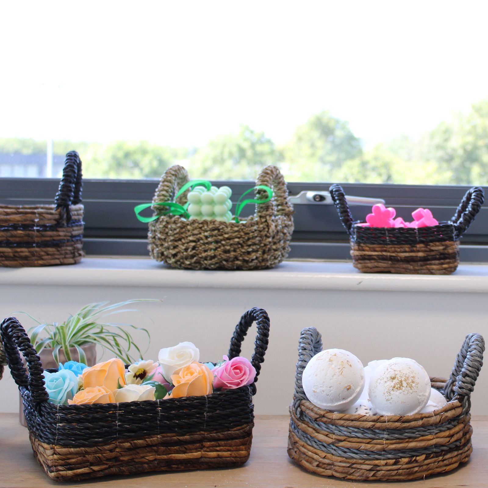Wicker baskets with decorative items on a windowsill