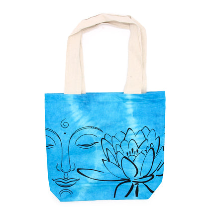 Tote bag with blue tie-dye design featuring a face and lotus flower on a white background
