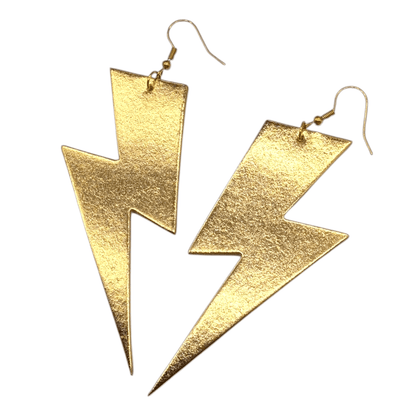 Gold lightning bolt earrings on a white background
