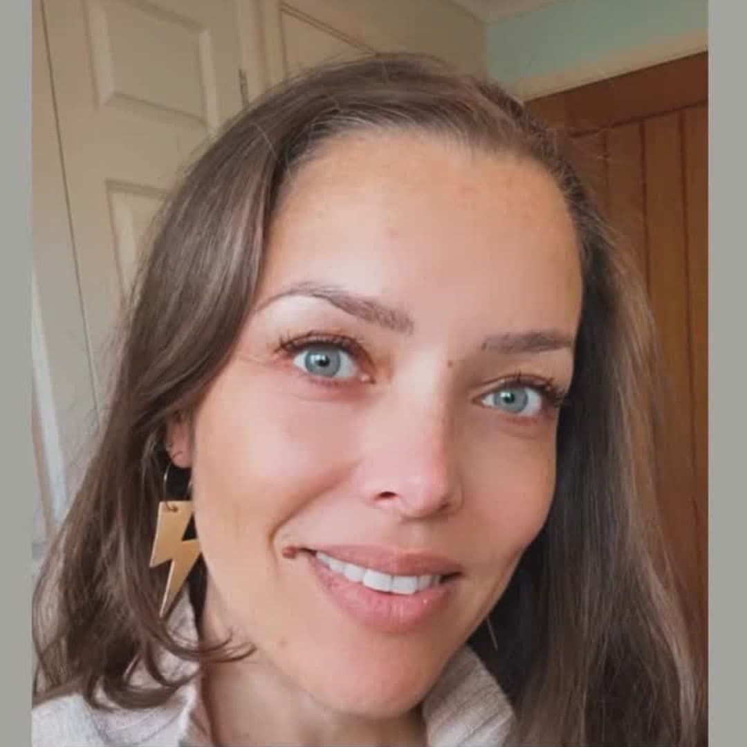 Close-up of a person with shoulder-length hair indoors.