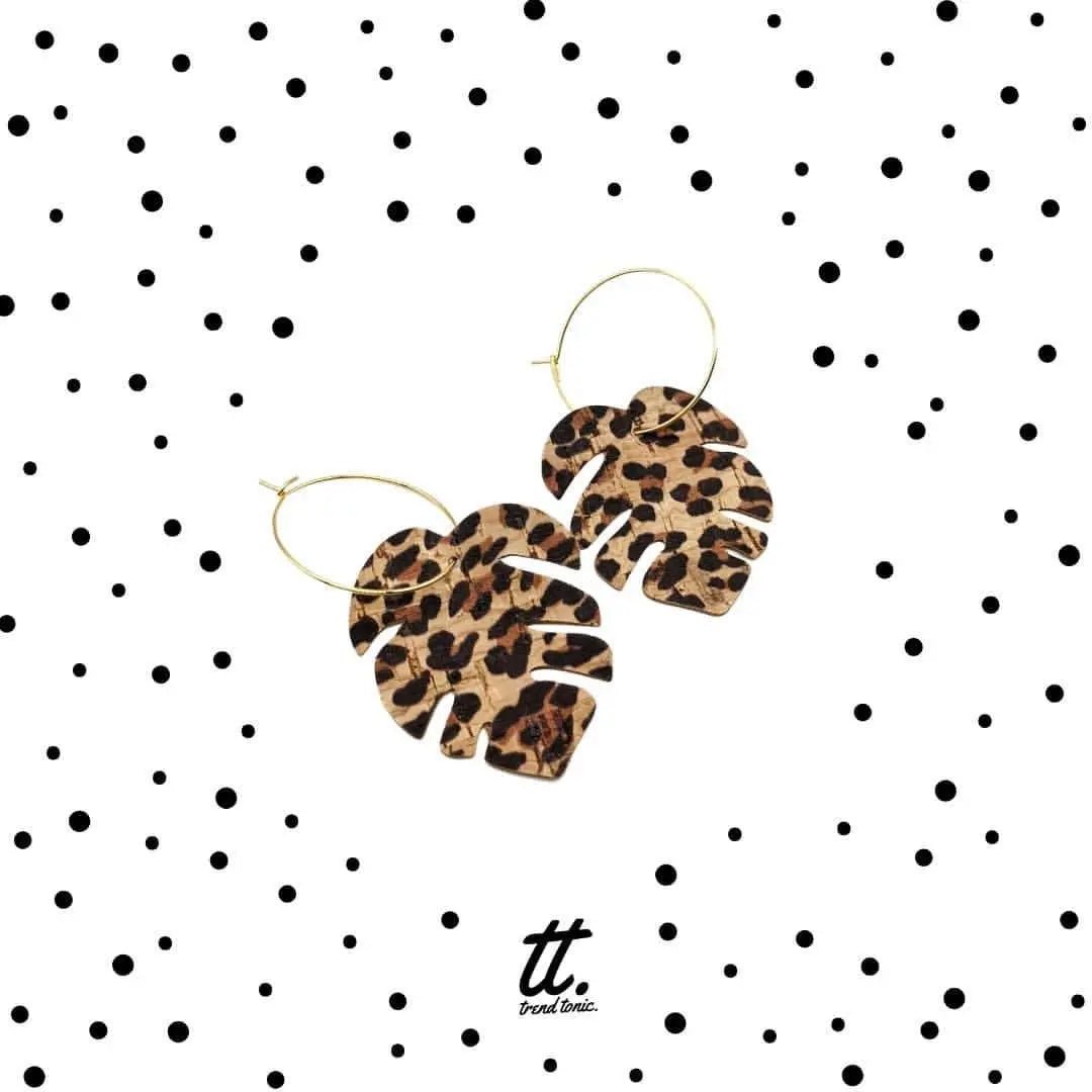 Leopard print earrings on a polka dot background with 'tt' brand logo.