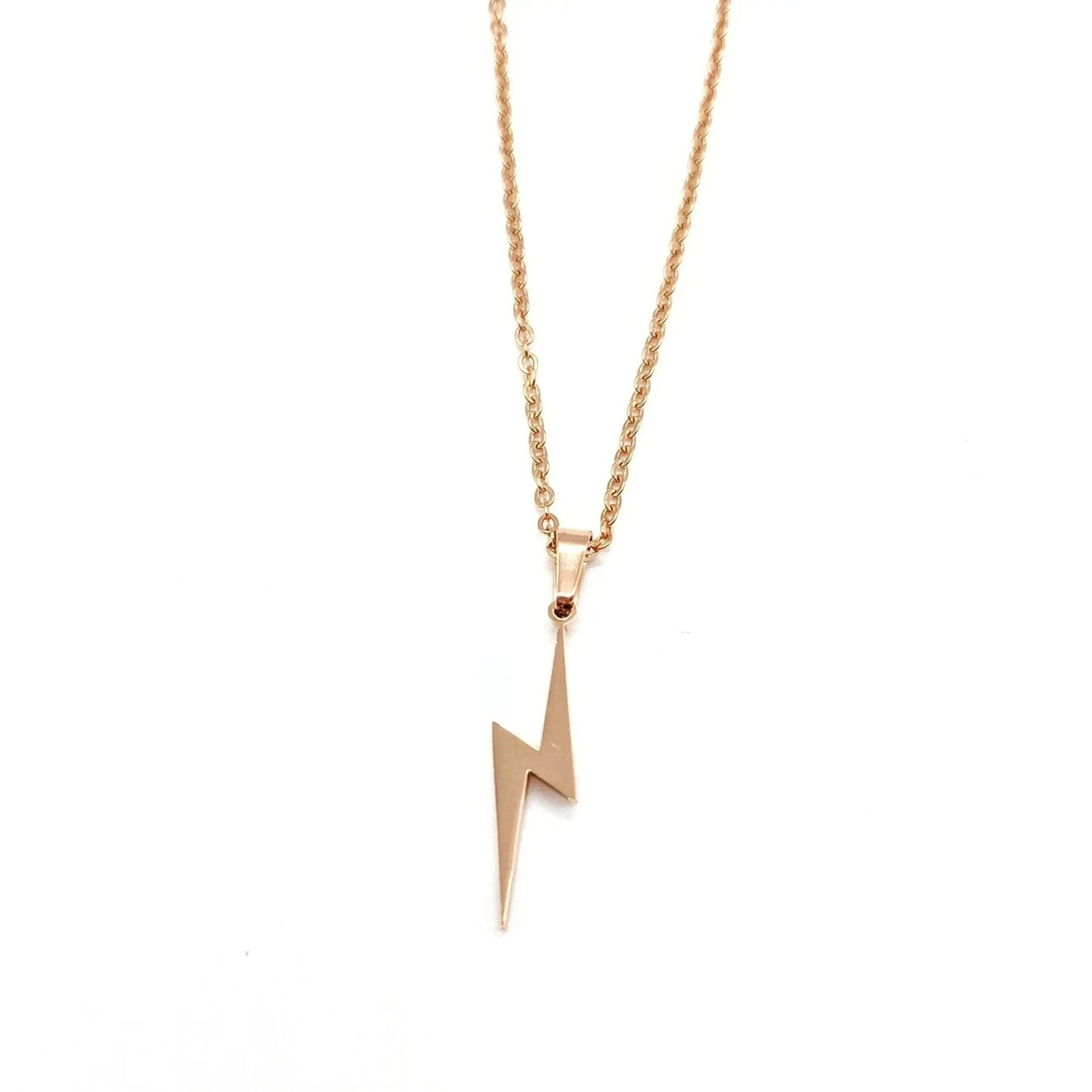 Rose gold lightning bolt necklace on a white background
