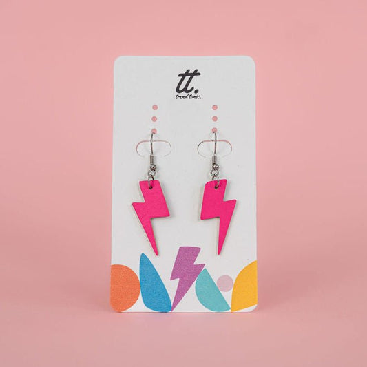 Pair of pink lightning bolt earrings on a branded card against a pink background