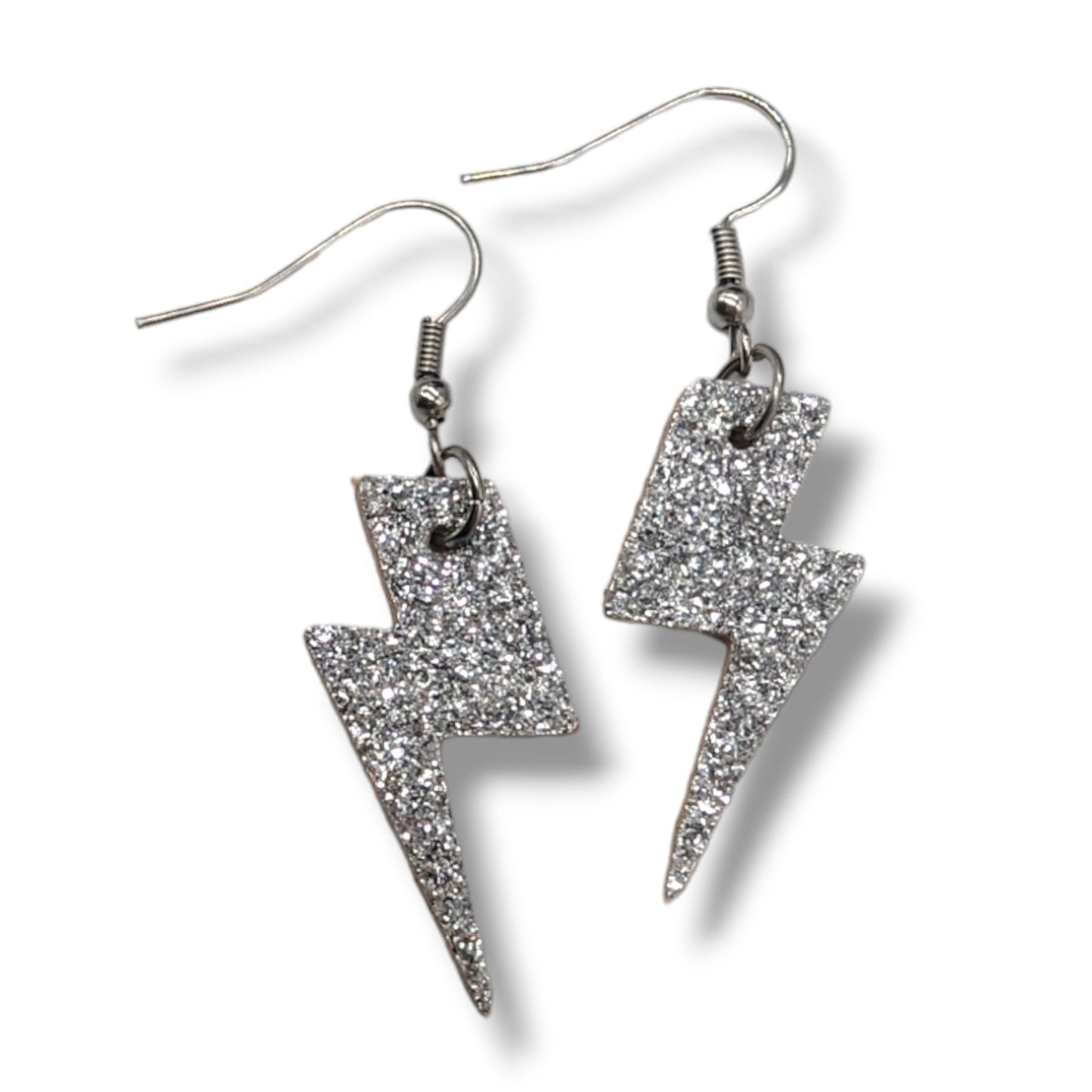 Silver glittery lightning bolt earrings on a white background