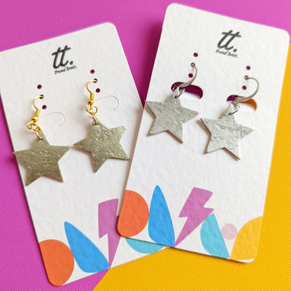 Star-shaped earrings on branded cards with a colorful background