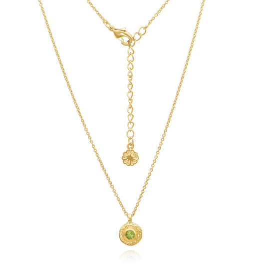 Gold necklace with a green gemstone pendant on a white background