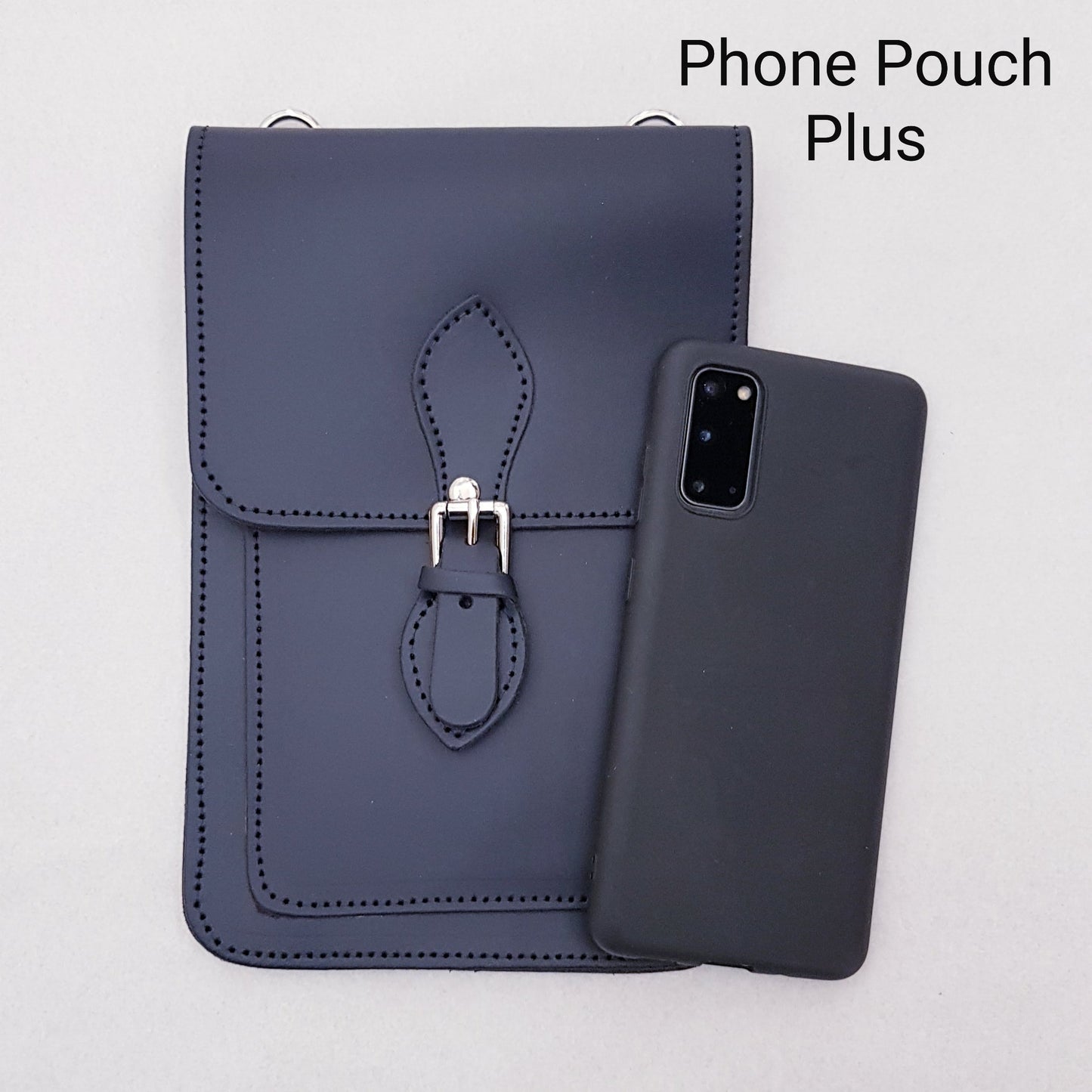 Navy blue phone pouch with strap and matching phone case on a light gray background
