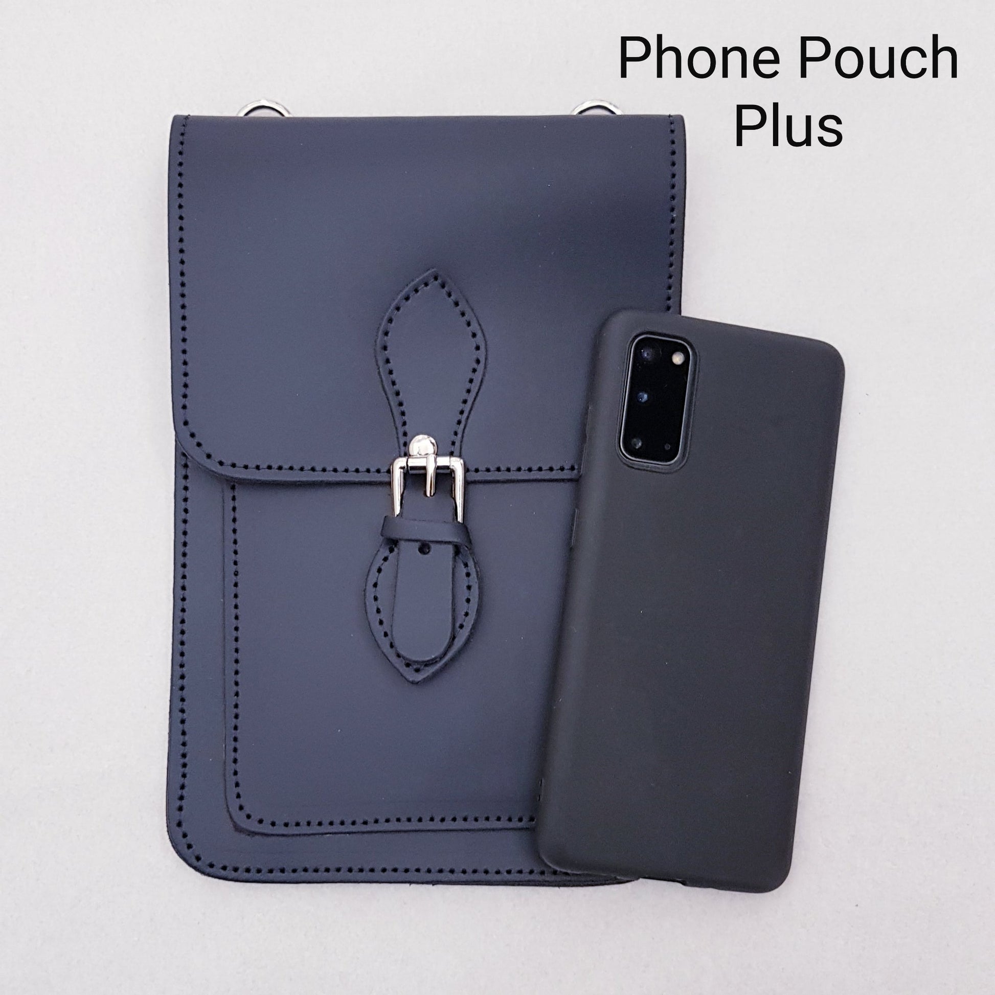 Navy blue phone pouch with strap and matching phone case on a light gray background