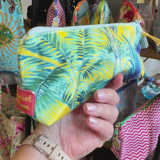 Hand turning the Palm Springs velvet pencil case to show the print, zip and tassel in the Apricot Moon shop