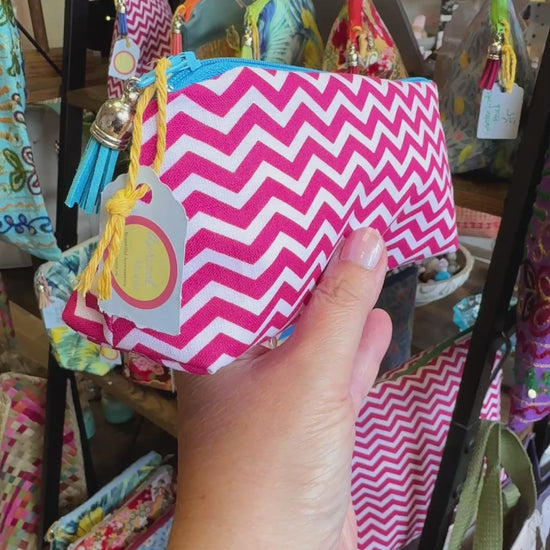 Hand turning the Raspberry Chevron pencil case to show the print, zip and tassel in the Apricot Moon shop