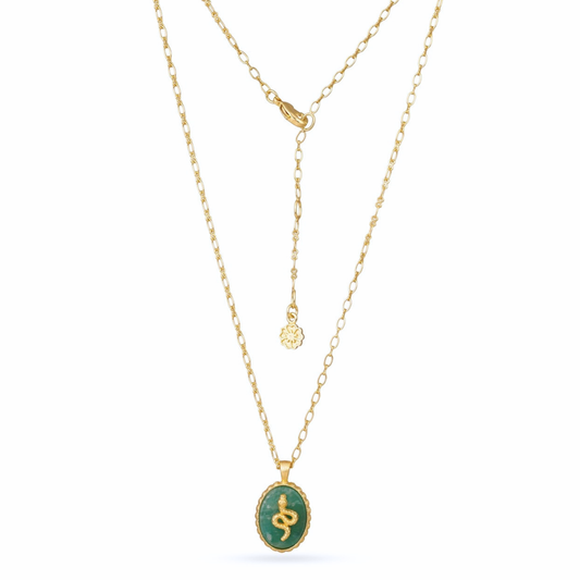 Gold necklace with a green pendant on a white background