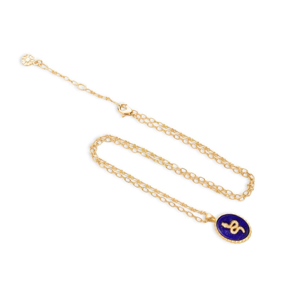 Gold necklace with a blue pendant on a white background